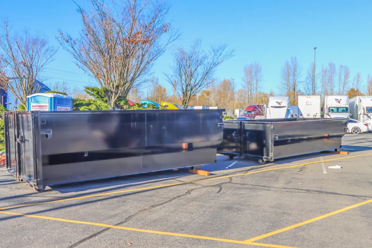 Professional dumpster rental service with roll-off container on residential driveway in St. Clair Shores